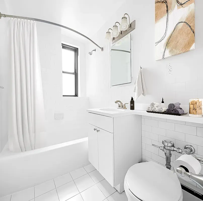 85 4th Avenue, Unit 3B Manhattan, NY 10003 - Photo 5 of 9 a bathroom with a sink a toilet and shower