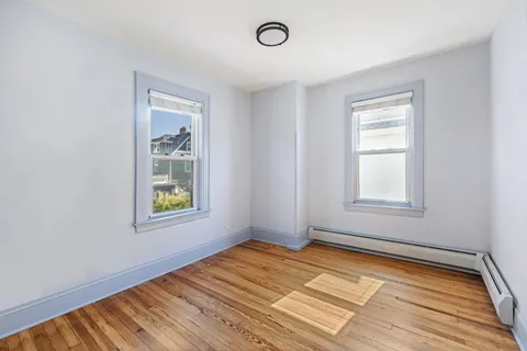 a bathroom with a toilet a sink a mirror and a bathtub