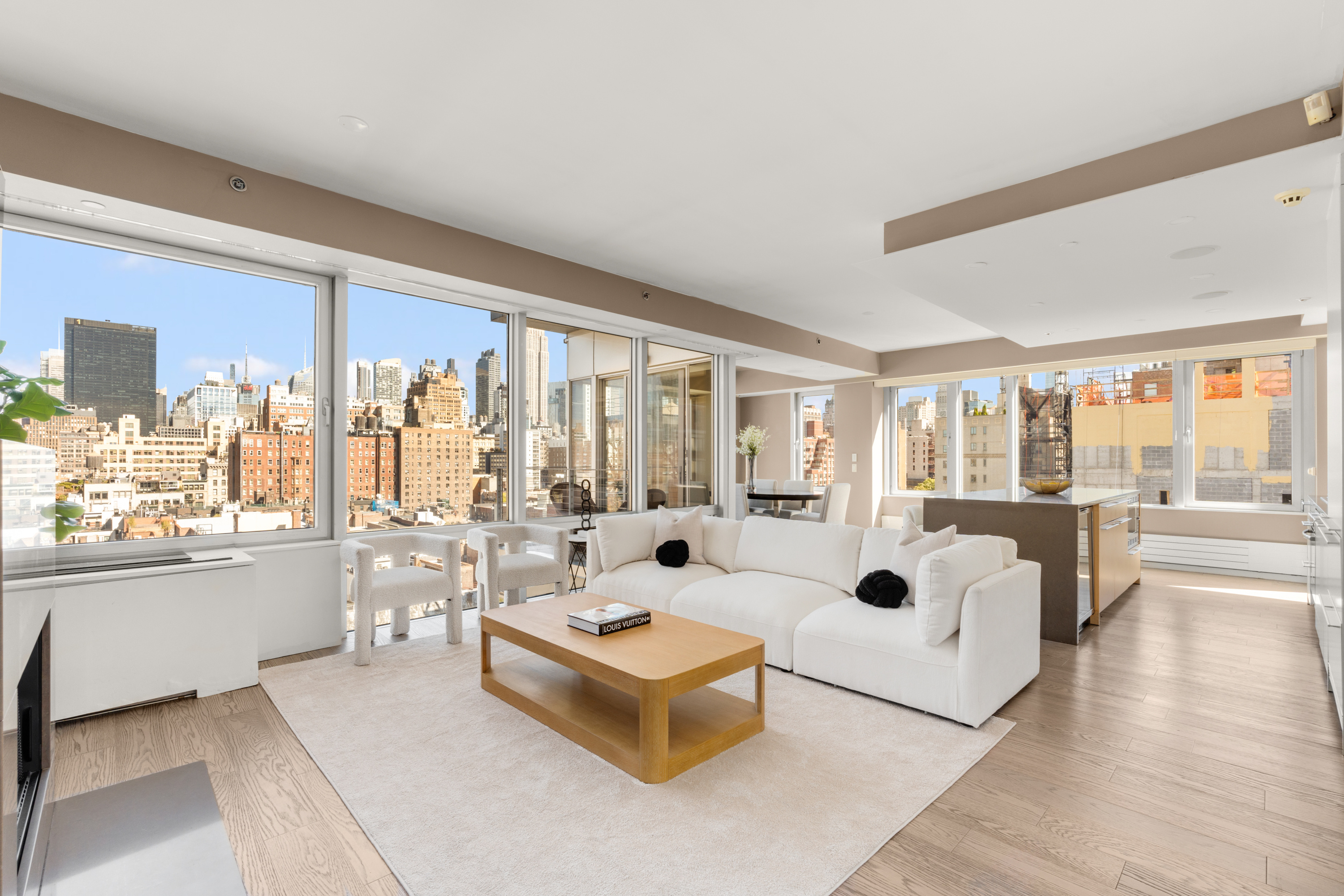 245 West 19th Street, Unit PH4 Manhattan, NY 10011 - Photo 1 of 10 a living room with furniture large windows a rug and white walls