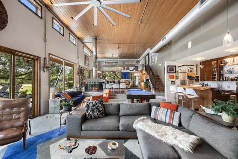 a living room with furniture and a lamp