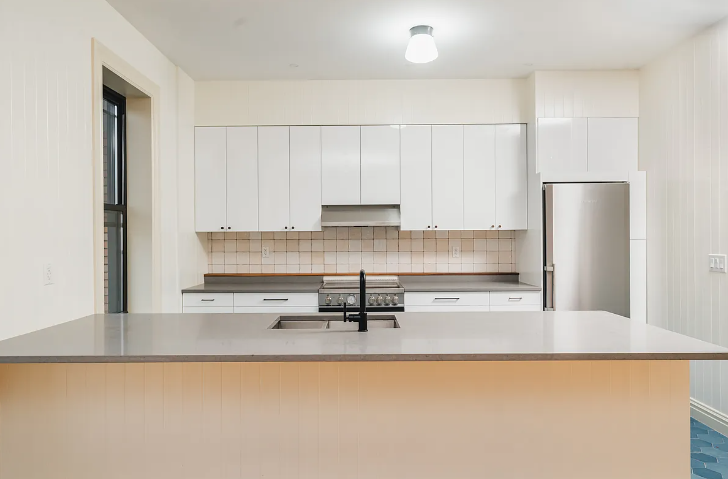 68-38 Forest Avenue, Unit 3R Queens, NY 11385 - Photo 4 of 15 a kitchen with stainless steel appliances a refrigerator a stove a sink a refrigerator and white cabinets