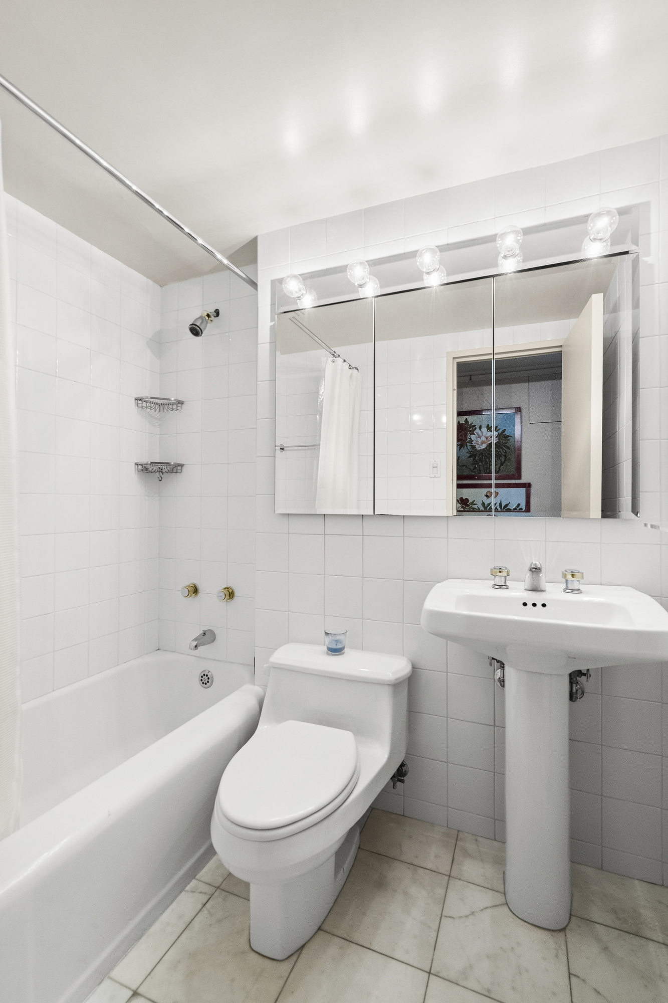 2 5th Avenue, Unit 15U Manhattan, NY 10011 - Photo 6 of 13 a bathroom with a sink toilet and shower