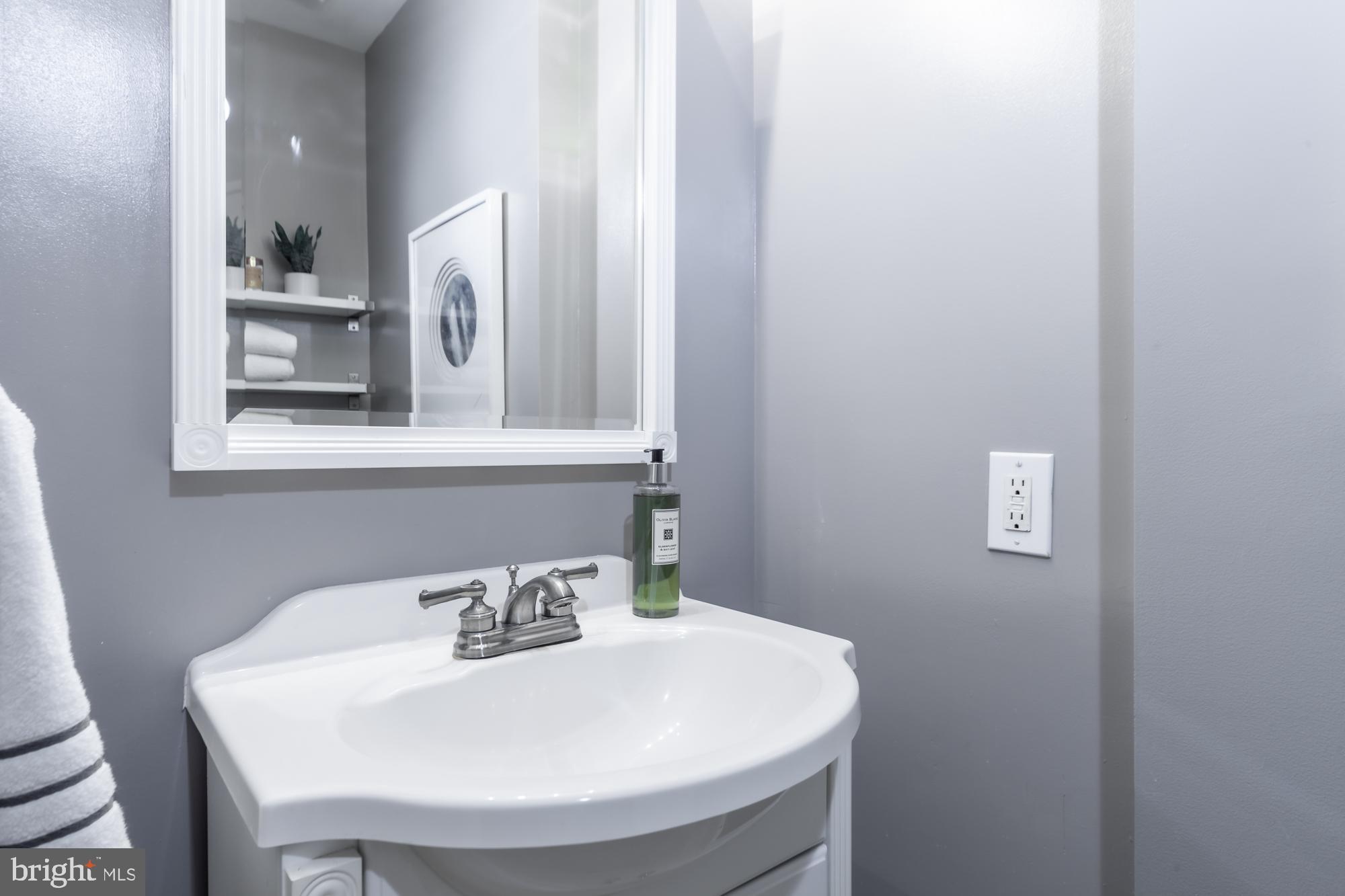 1715 15th Street Northwest, Unit 101 Washington, DC 20009 - Photo 9 of 23 a bathroom with a sink and a mirror