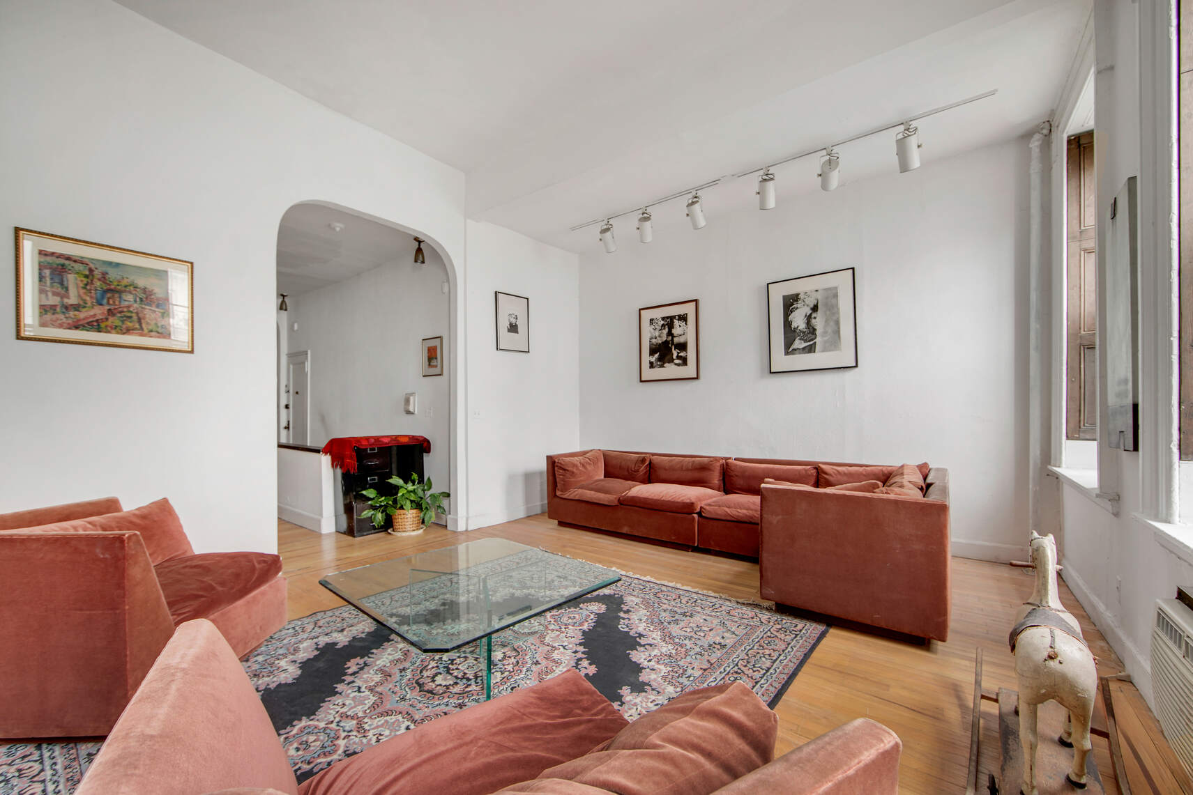 337 East 18th Street Manhattan, NY 10003 - Photo 2 of 16 a living room with furniture and a couch