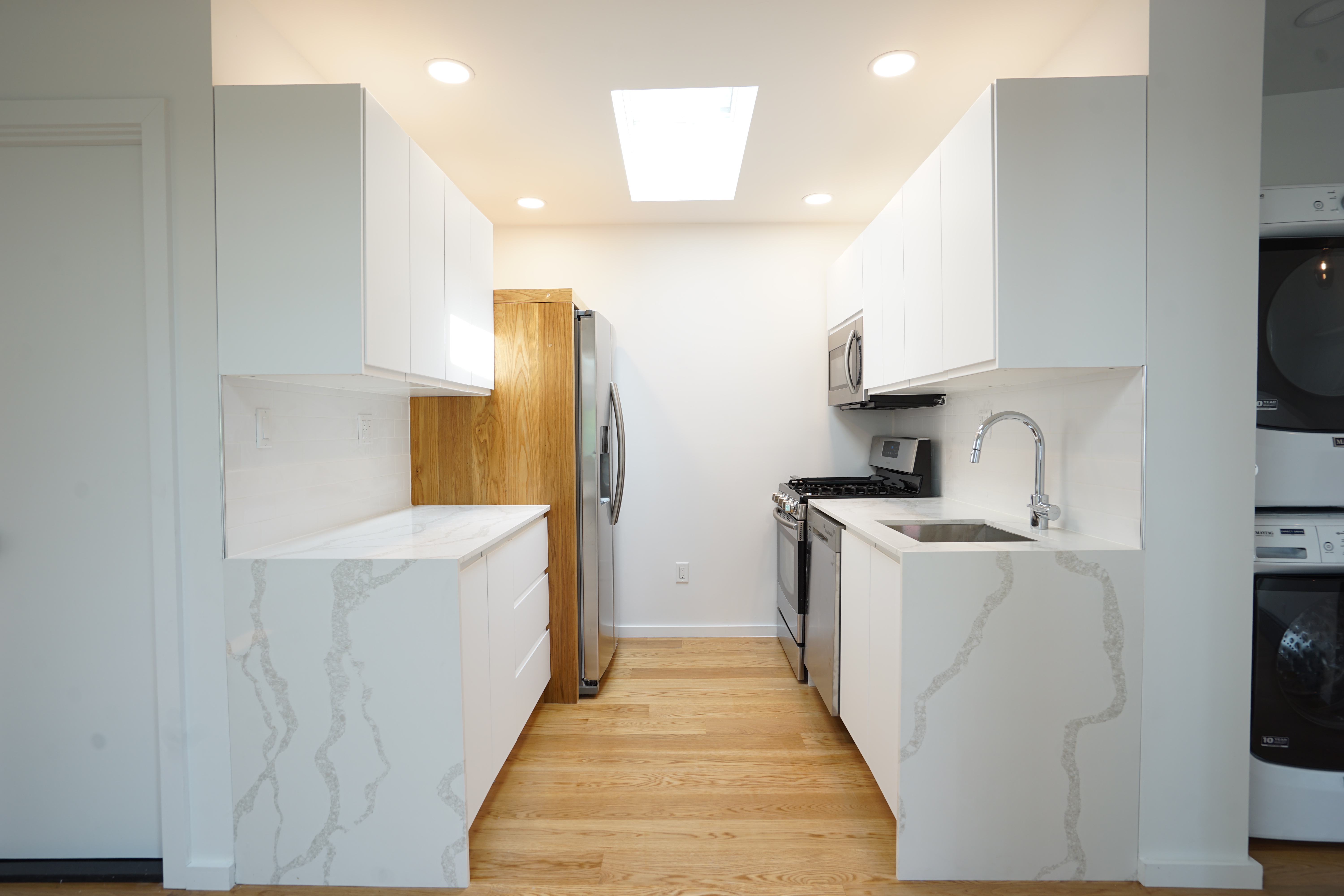 1 Luquer Street, Unit 2 Brooklyn, NY 11231 - Photo 3 of 9 a kitchen with a sink a stove top oven and white cabinets