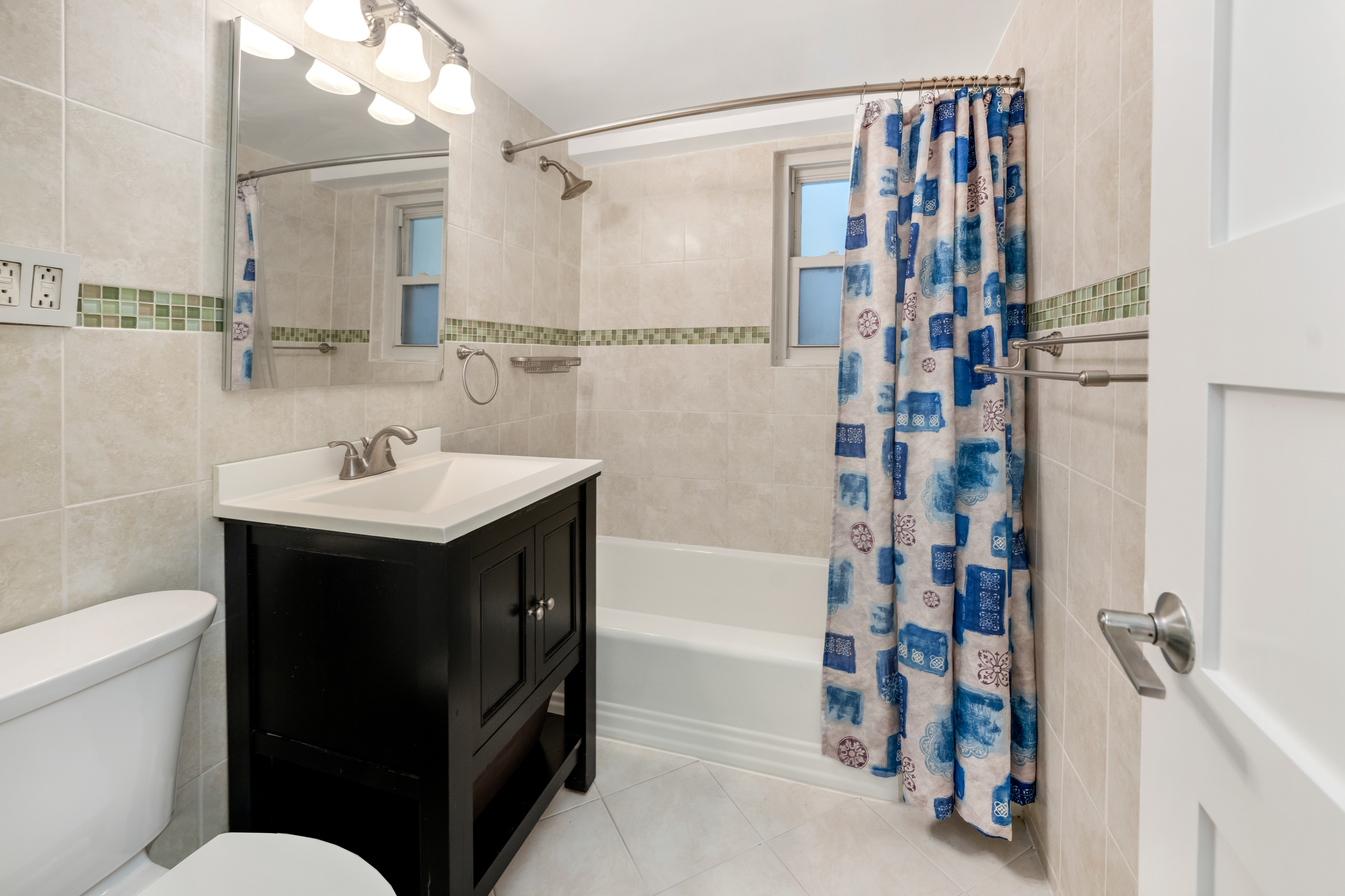 345 East 56th Street, Unit 7J Manhattan, NY 10022 - Photo 10 of 13 a bathroom with a sink and a mirror