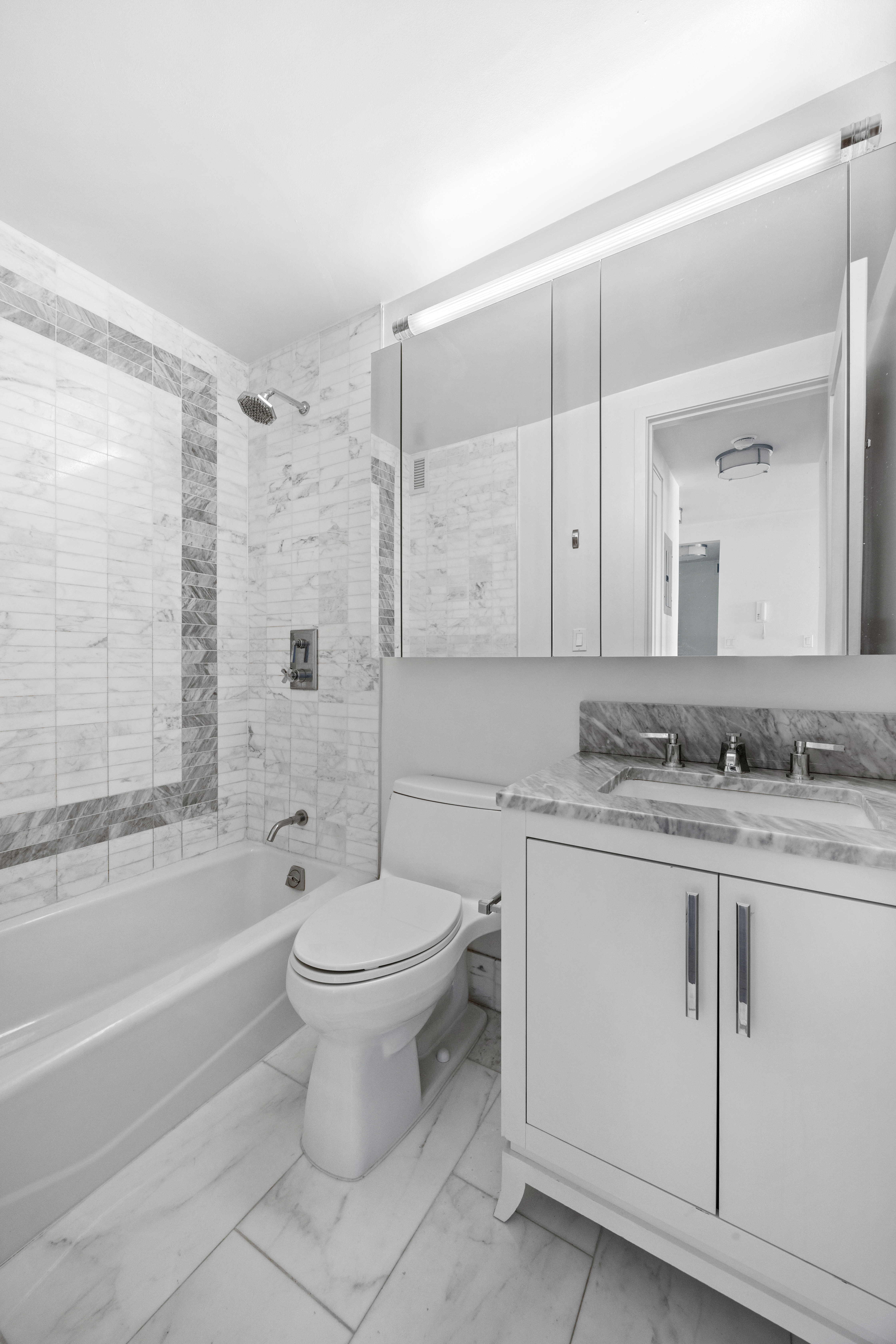 200 East 94th Street, Unit 2012 Manhattan, NY 10128 - Photo 6 of 9 a bathroom with a sink a toilet and a bathtub