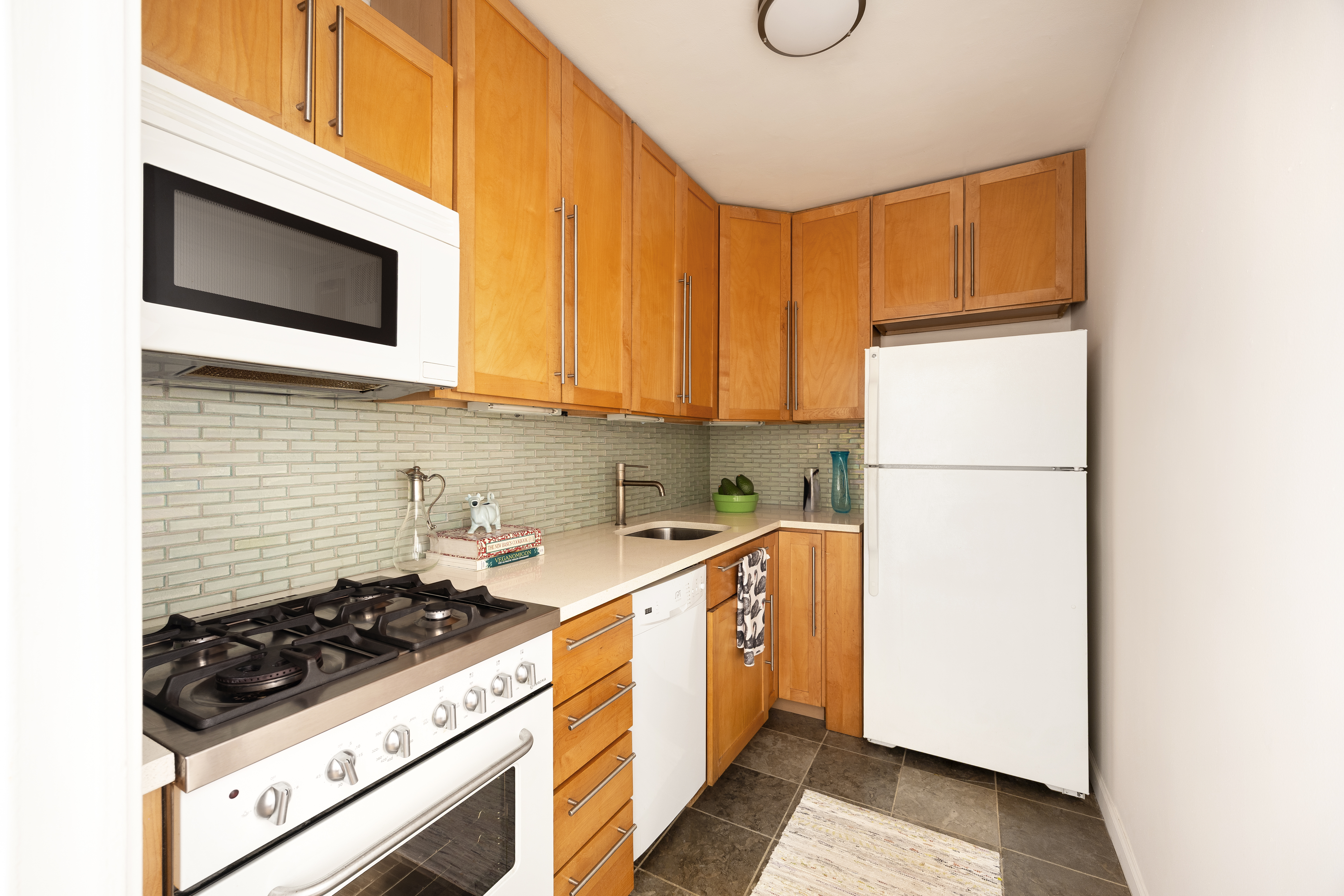 85 Livingston Street, Unit 16N Brooklyn, NY 11201 - Photo 7 of 9 a kitchen with a sink a stove and a refrigerator