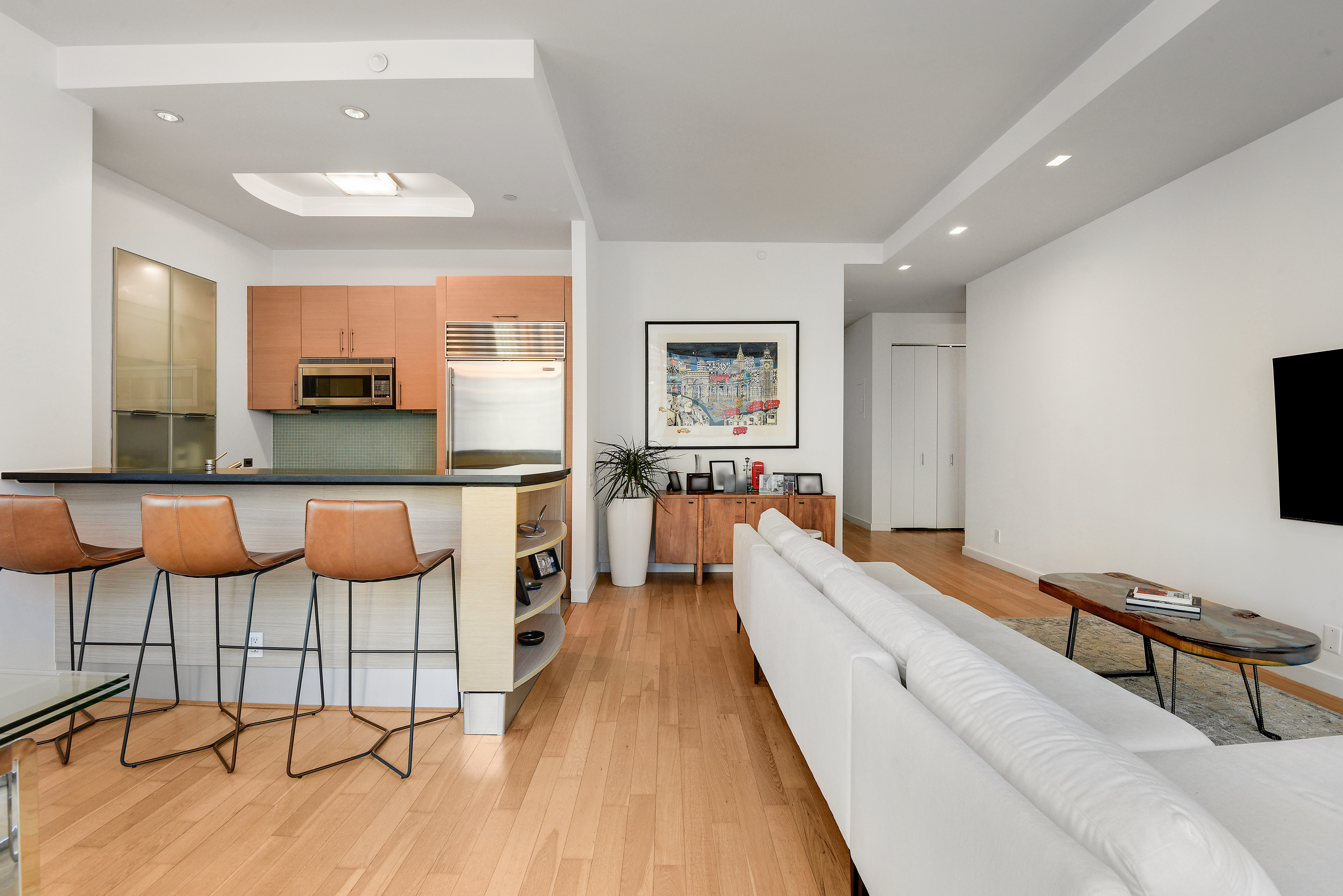 325 5th Avenue, Unit 16C Manhattan, NY 10016 - Photo 3 of 25 a large living room with a couch and a flat screen tv