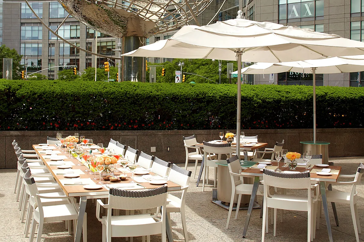 1 Central Park West, Unit 1218 Manhattan, NY 10023 - Photo 10 of 11 a view of a patio with table and chairs under an umbrella