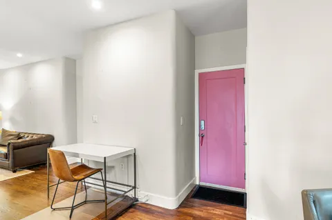 a view of a room with furniture and wooden floor