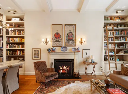 a living room with furniture a bookshelf and a fireplace