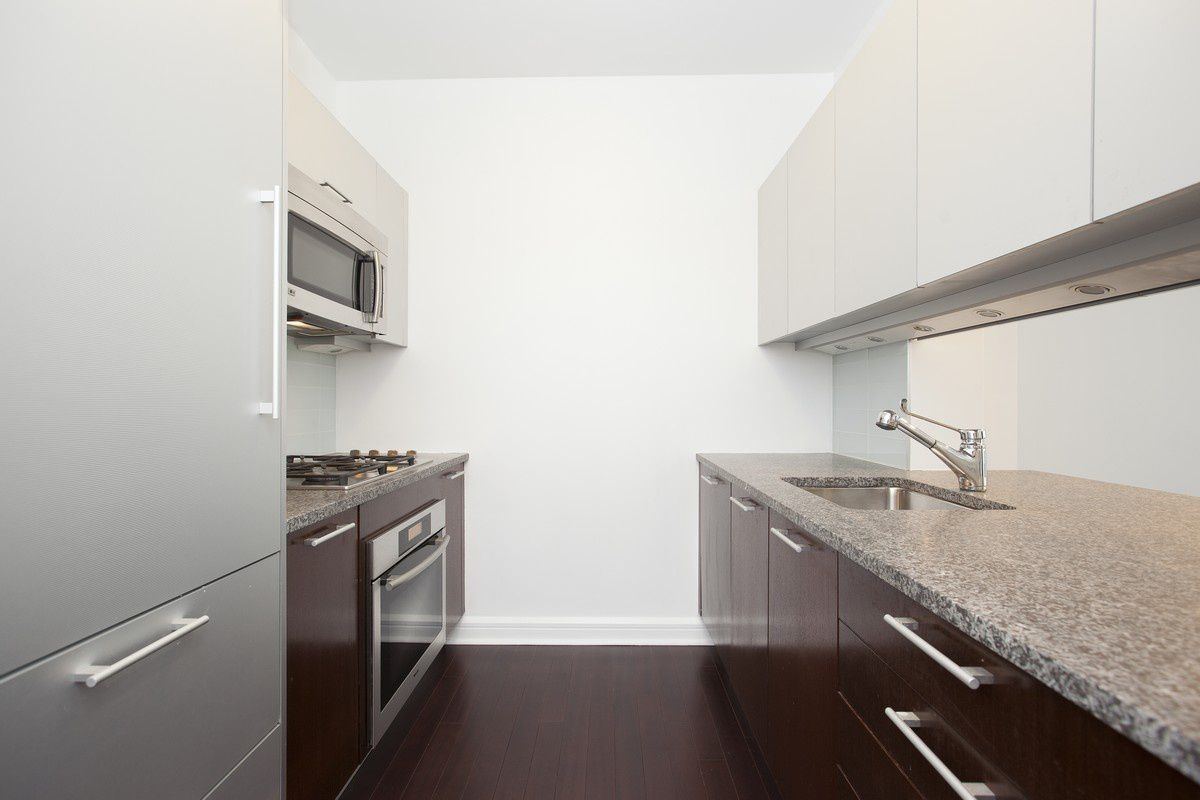 100 Riverside Boulevard, Unit 9D Manhattan, NY 10069 - Photo 3 of 14 a kitchen with stainless steel appliances granite countertop a sink and a stove