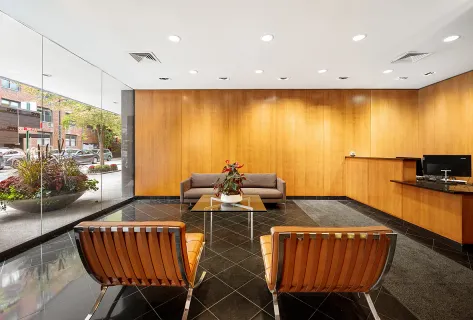 a view of a dining room with furniture a kitchen and chandelier