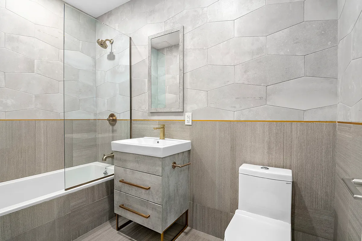 550 Van Buren Street, Unit 2A Brooklyn, NY 11221 - Photo 4 of 5 a bathroom with a sink a toilet and shower