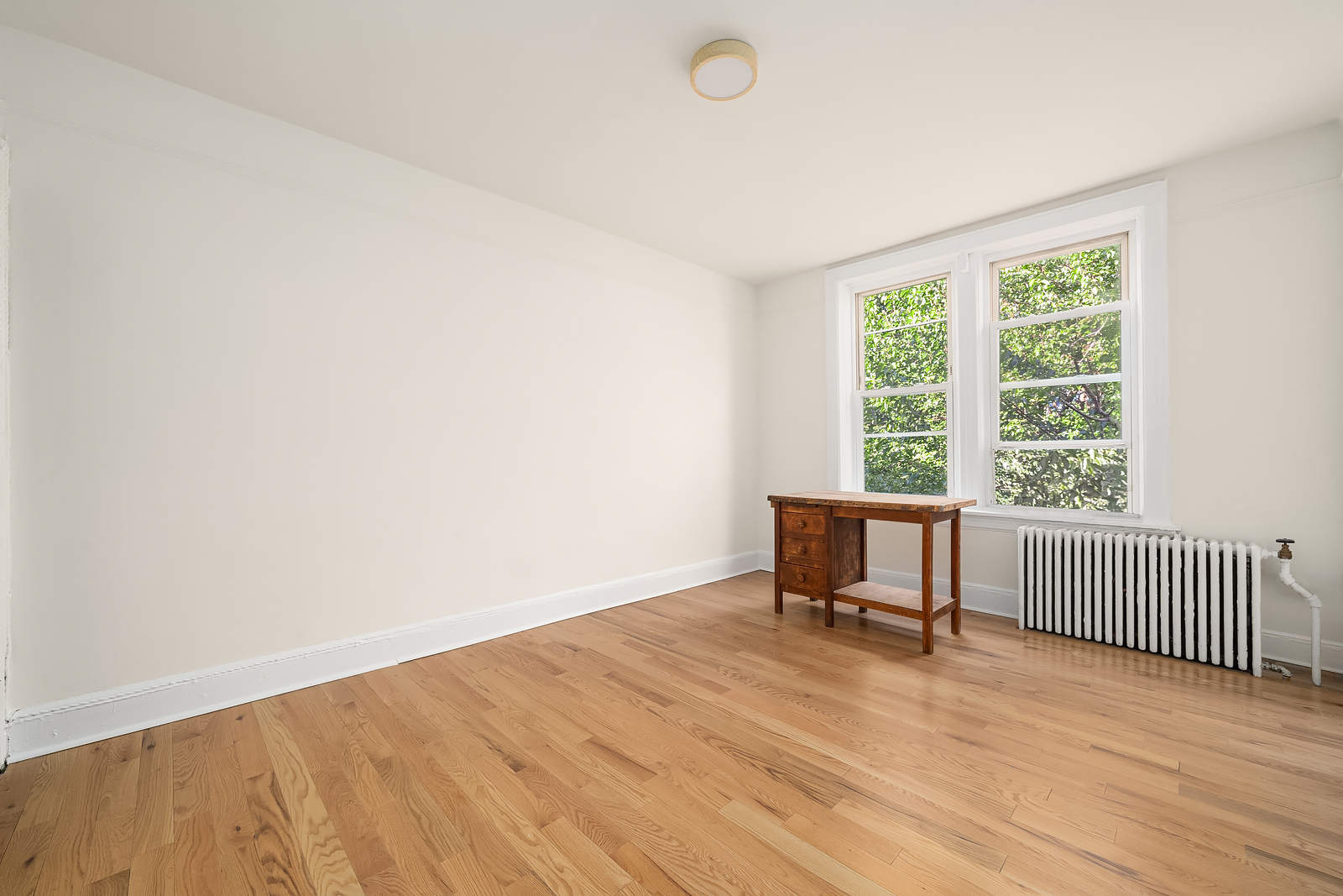 439 Union Street, Unit 3 Brooklyn, NY 11231 - Photo 7 of 9 an empty room with wooden floor and a window