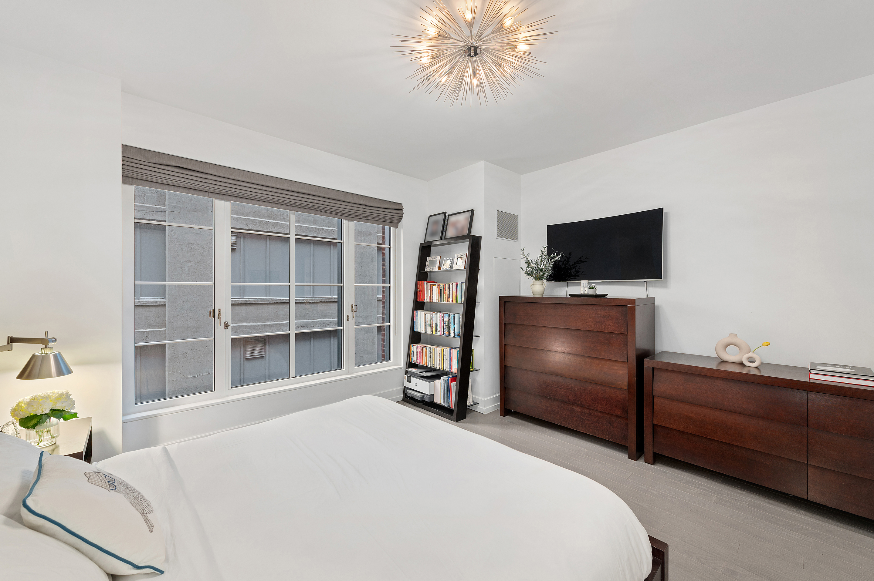 70 Charlton Street, Unit 16C Manhattan, NY 10014 - Photo 10 of 31 a bedroom with a bed and a flat screen tv