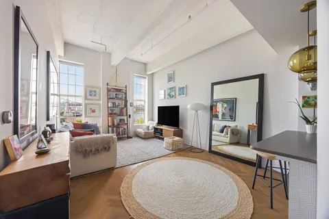 a living room with fireplace furniture and a large window