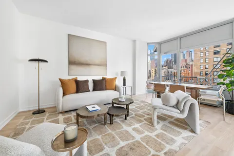 a living room with furniture and a floor to ceiling window