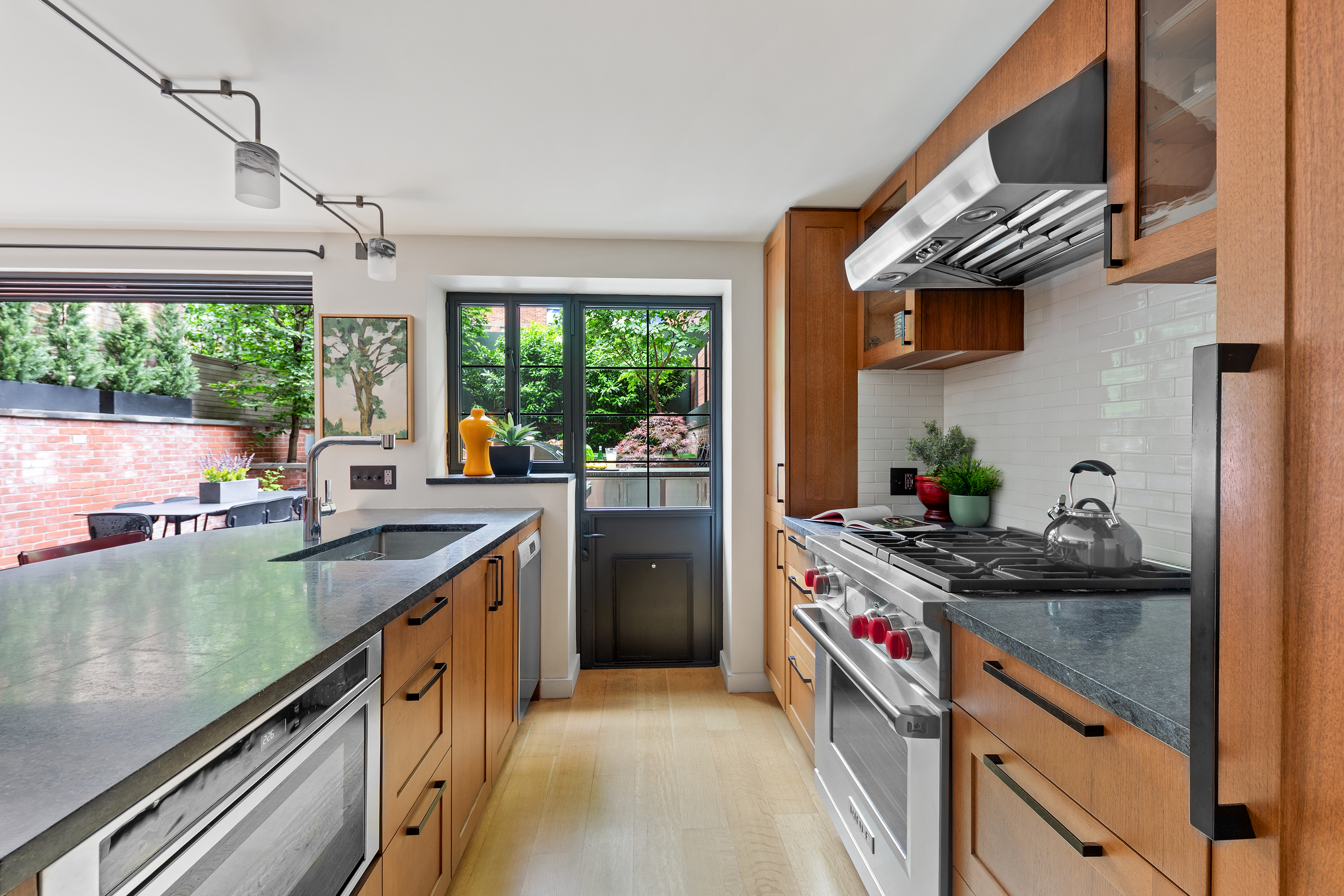 21 Bethune Street, Unit GARDEN Manhattan, NY 10014 - Photo 6 of 12 a kitchen that has a sink and a stove