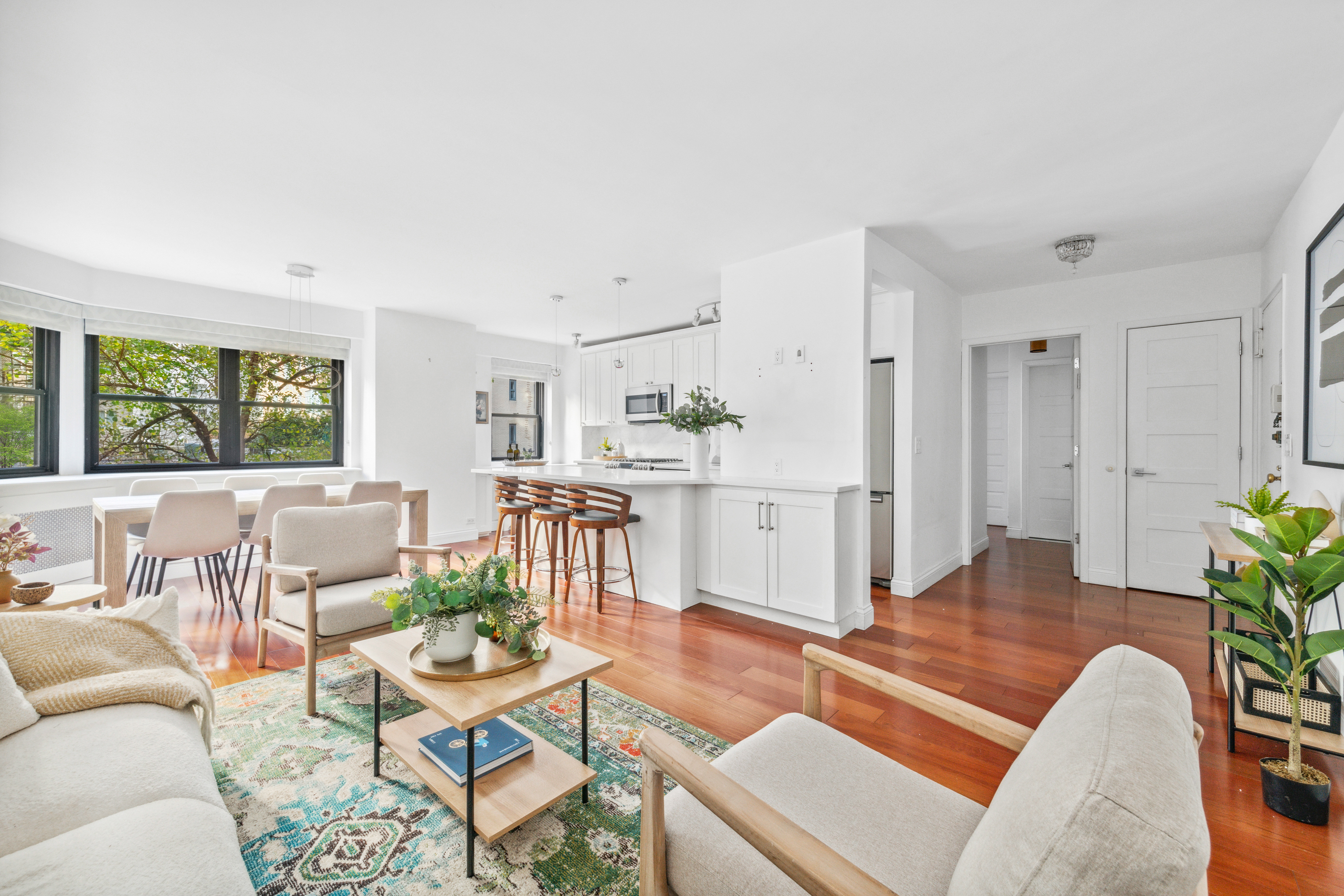 176 East 77th Street, Unit 2K Manhattan, NY 10075 - Photo 4 of 17 a living room with furniture and a large window