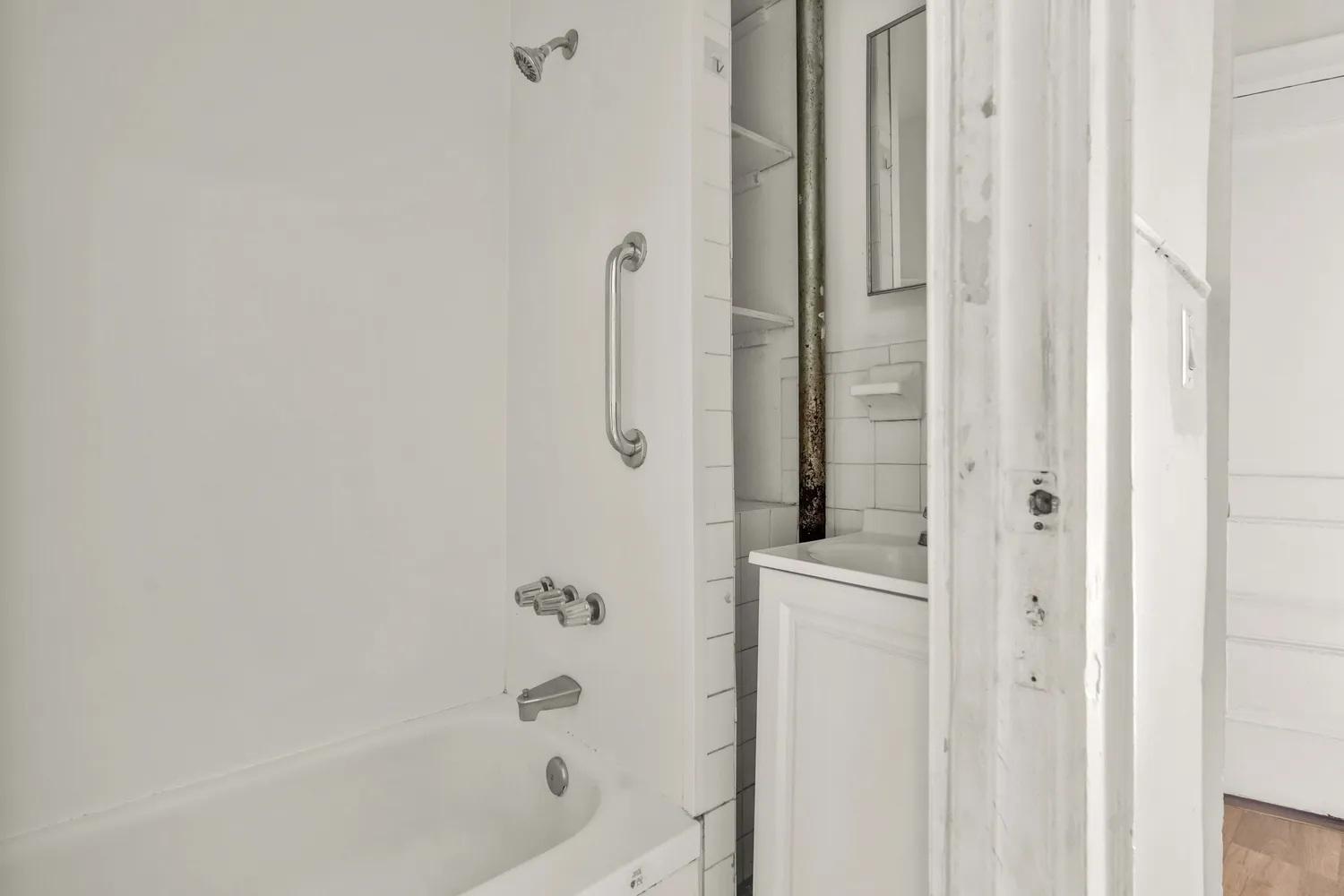 a bathroom with a bathtub and a shower