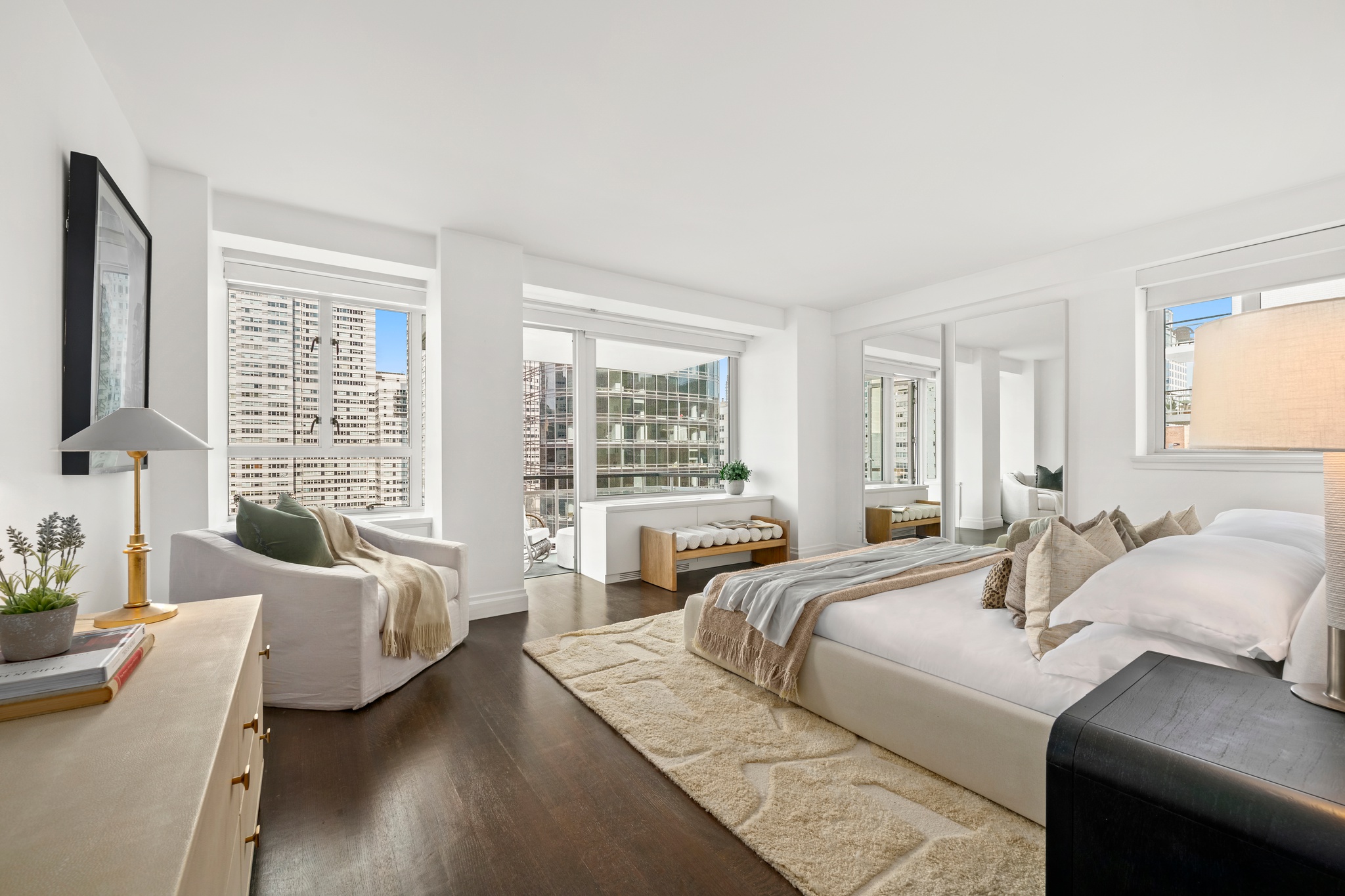 200 East 66th Street, Unit D1205 Manhattan, NY 10065 - Photo 6 of 33 a bedroom with a bed couch and a large window