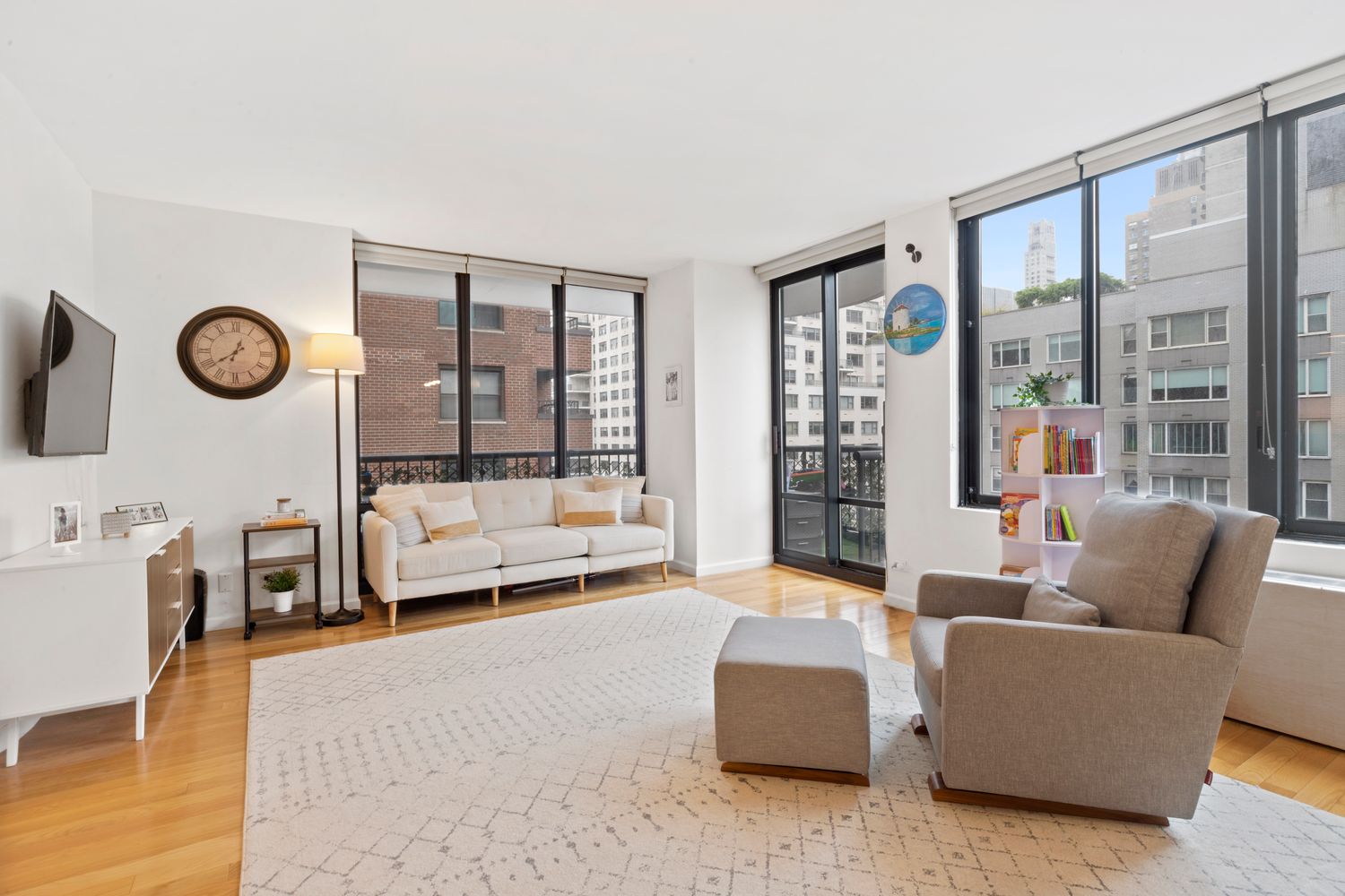 304 East 65th Street, Unit 12B Manhattan, NY 10065 - Photo 1 of 11 a living room with furniture and a large window
