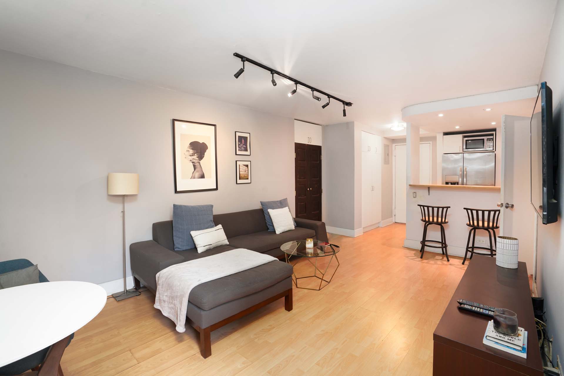 301 East 75th Street, Unit 2G Manhattan, NY 10021 - Photo 2 of 14 a living room with furniture and a table
