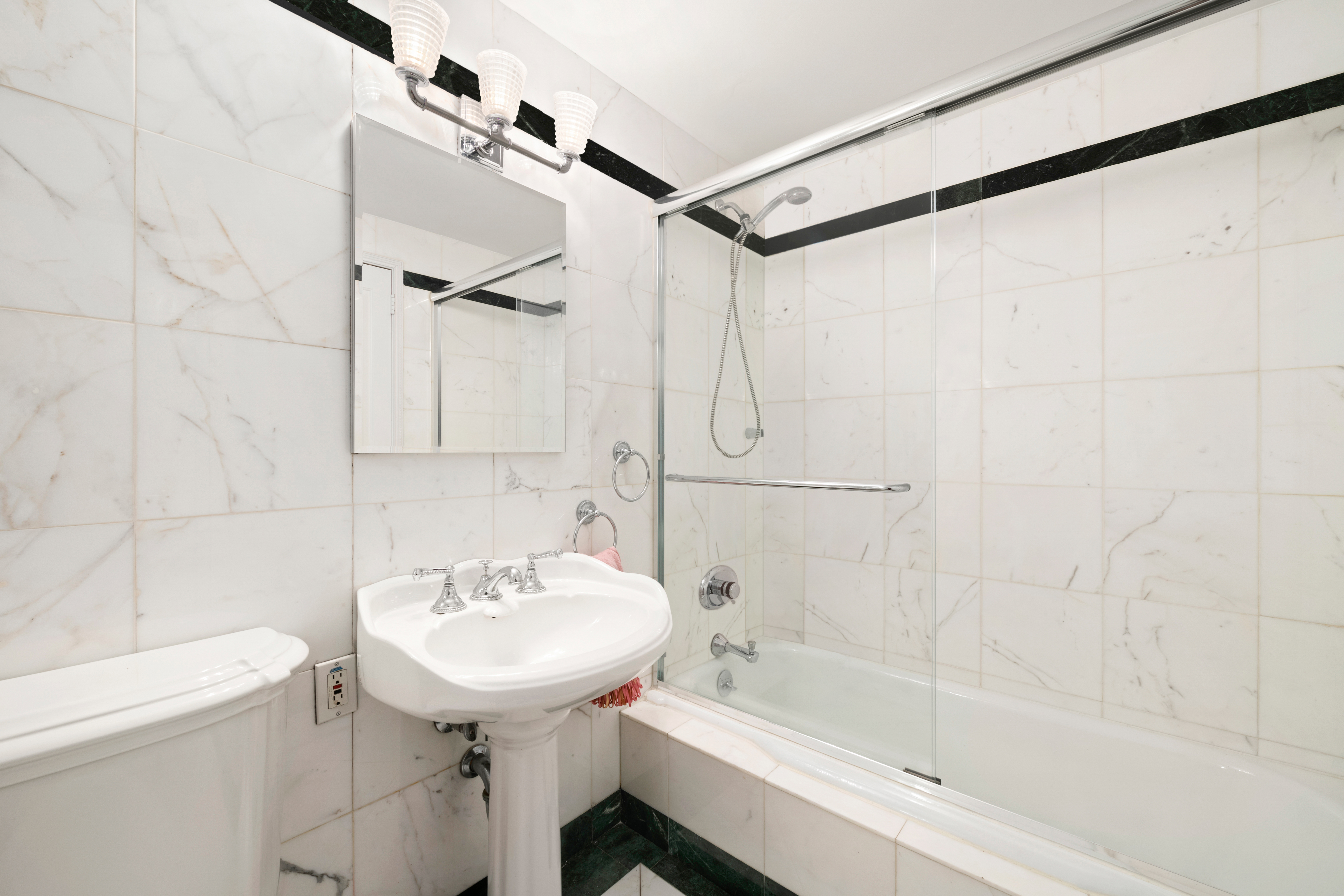 333 East 69th Street, Unit 10J Manhattan, NY 10021 - Photo 7 of 12 a bathroom with a sink toilet and shower