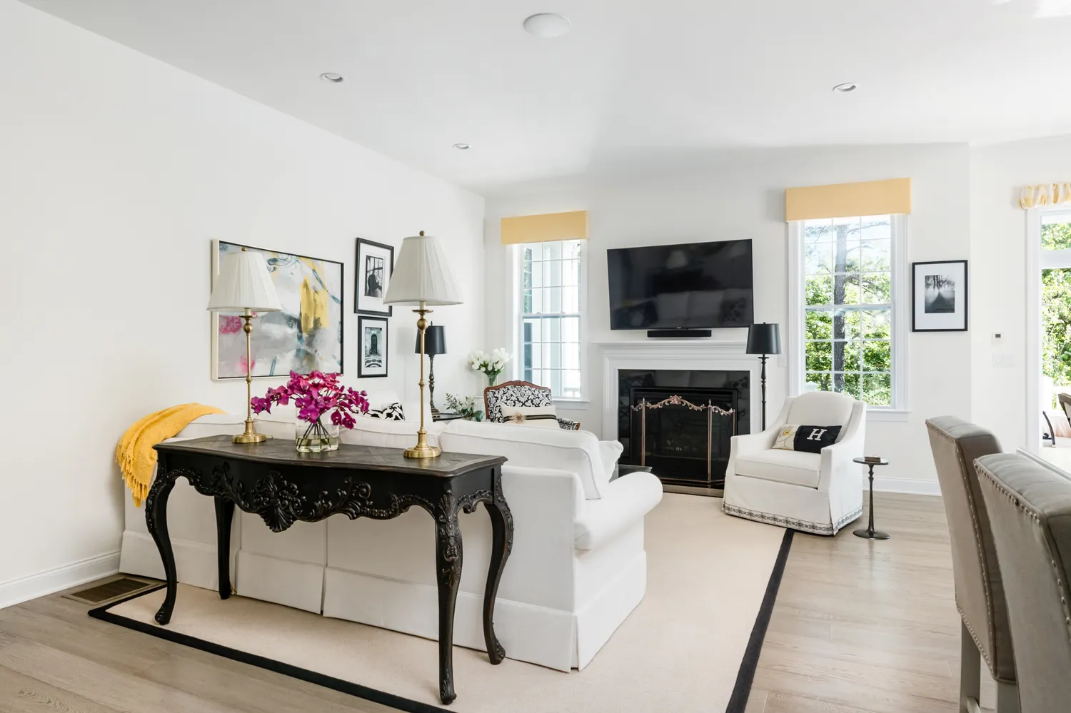 a living room with furniture a flat screen tv and a fireplace