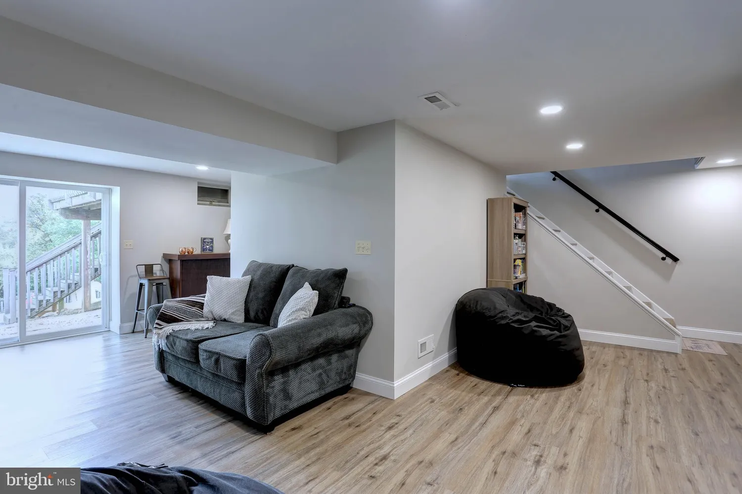 a living room with furniture and a book shelf