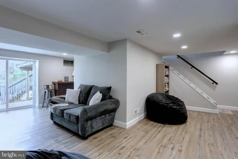 a living room with furniture and a book shelf