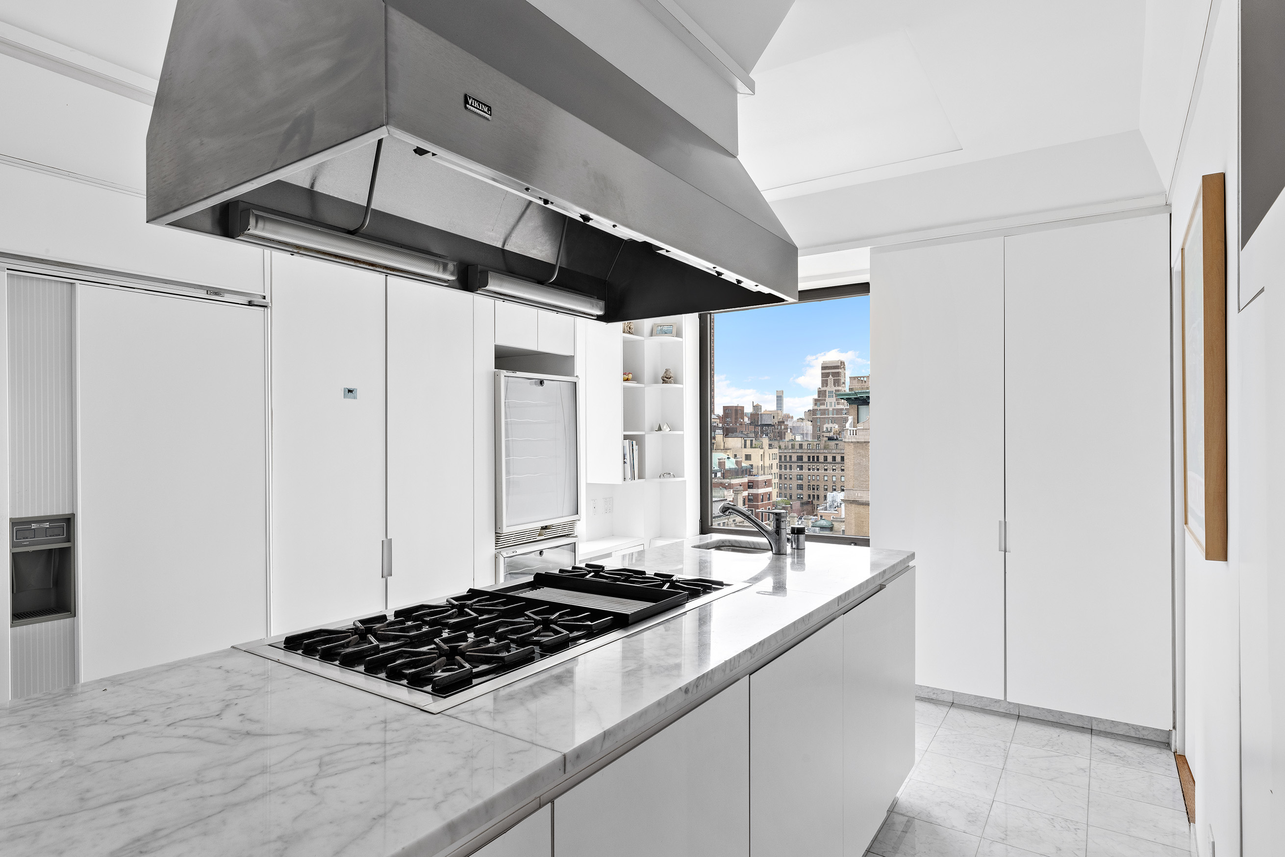 1115 5th Avenue, Unit 15A Manhattan, NY 10128 - Photo 15 of 27 a kitchen with stainless steel appliances granite countertop a stove and a refrigerator