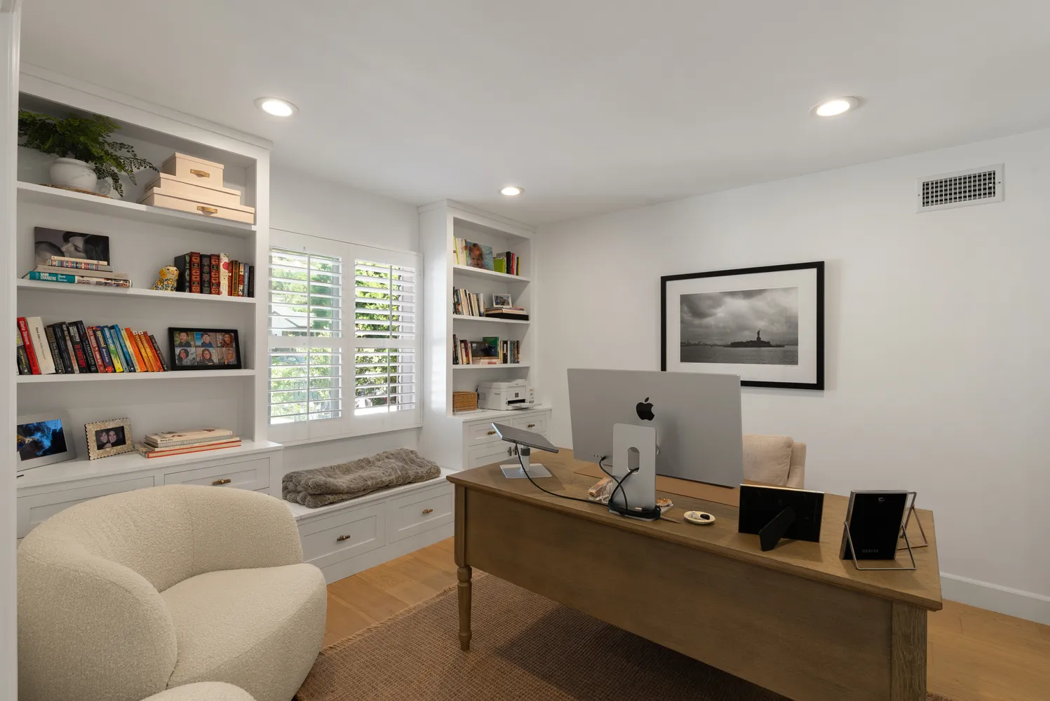 a living room with furniture and a book shelf