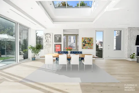 a dining room with wooden floor and large windows