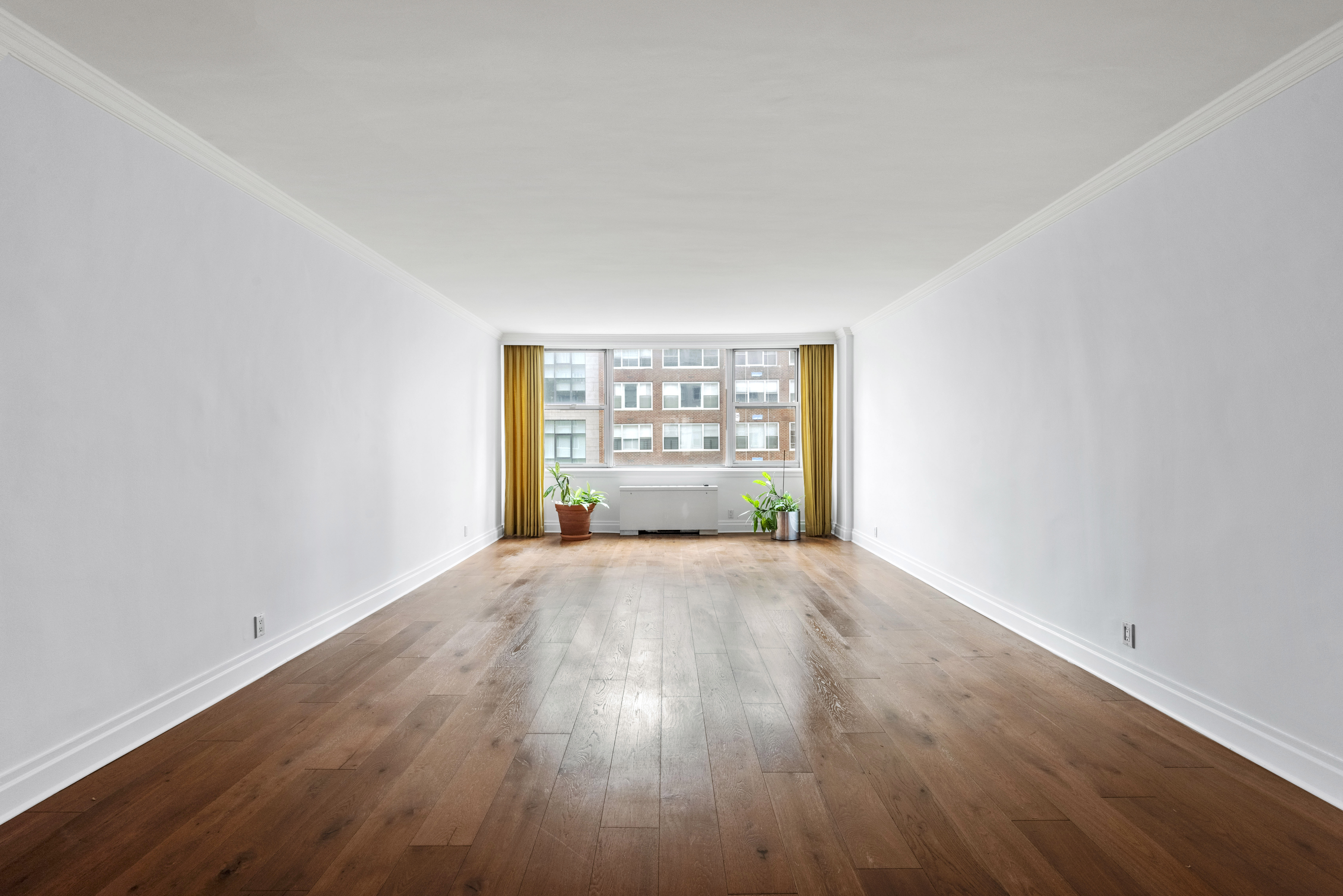 175 East 62nd Street, Unit 12A Manhattan, NY 10065 - Photo 19 of 24 an empty room with wooden floor and windows