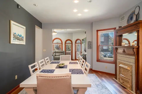 a dining room with furniture a rug and wooden floor