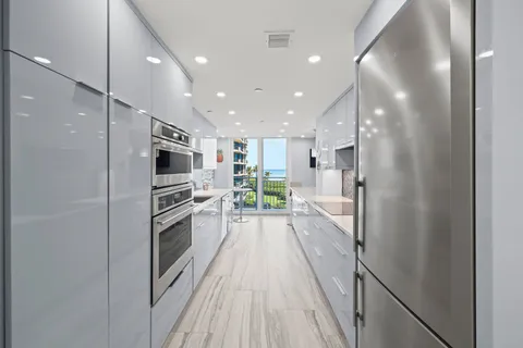 a kitchen with a sink and large window