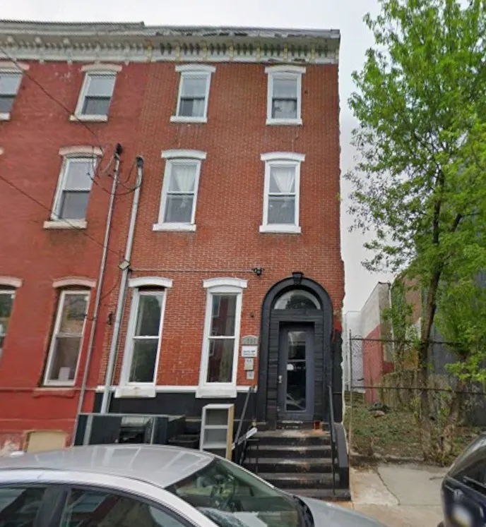 a front view of a building with garden