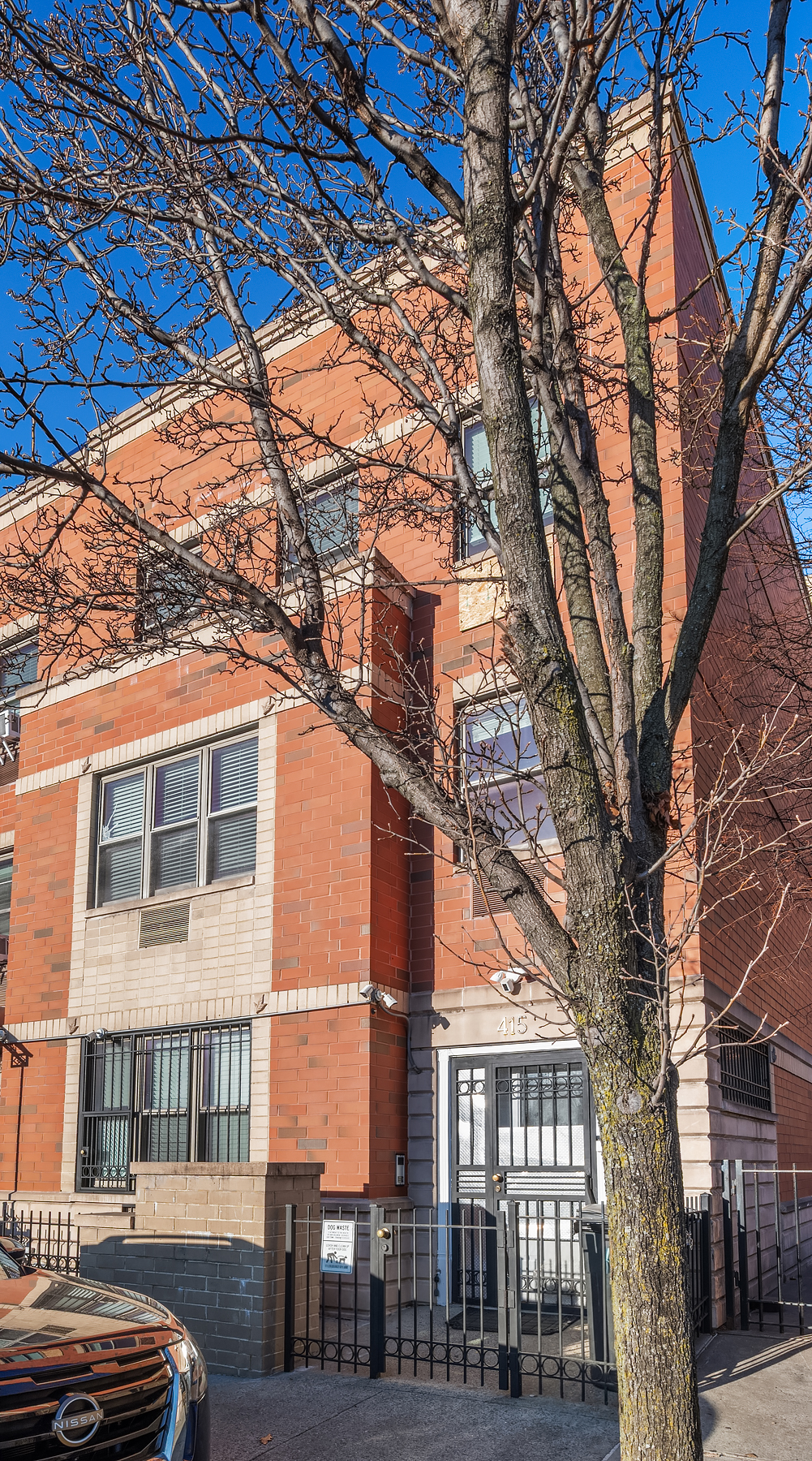 415 East 160th Street, Unit 3 Bronx, NY 10451 - Photo 9 of 10 a front view of a building with large trees