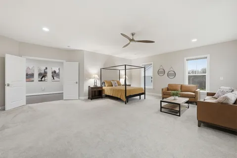 a bedroom with furniture and a flat screen tv