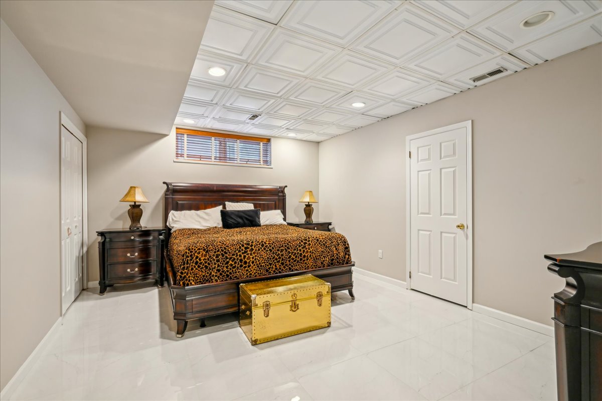 Johnston Drive Watchung, NJ 07069 - Photo 56 of 85 a bedroom with a bed and a chandelier