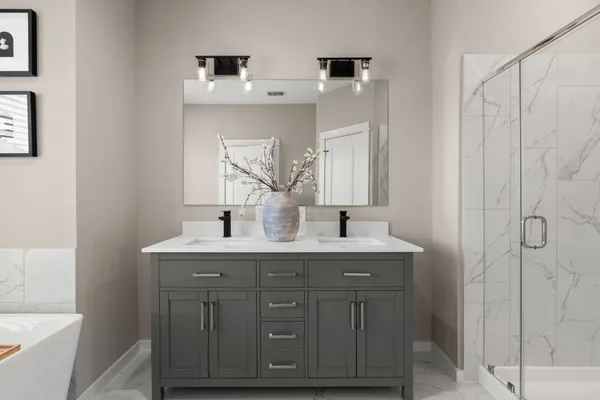 a bathroom with a granite countertop sink and a mirror