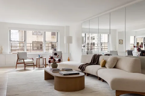 a living room with furniture and a lamp