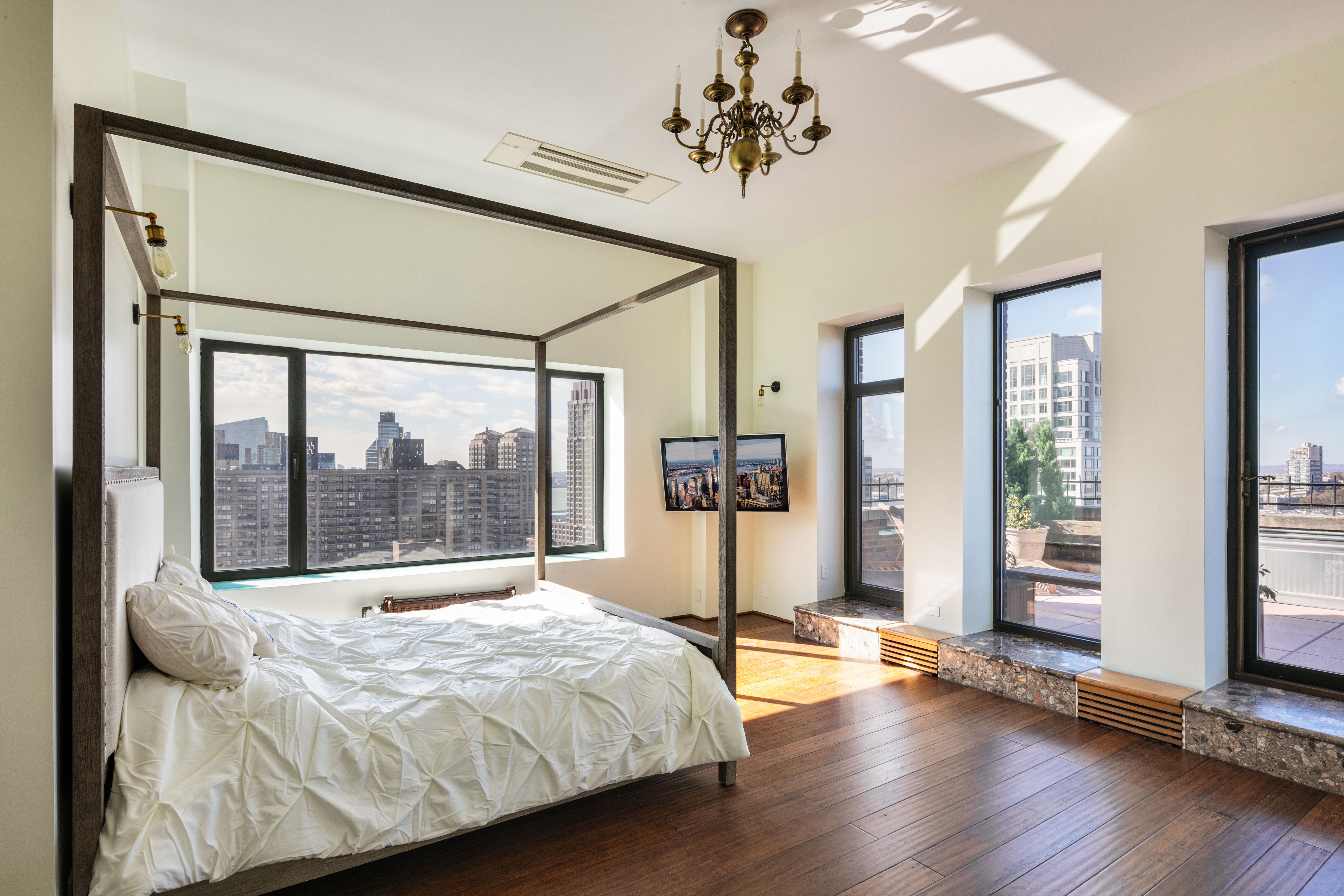 263 West End Avenue, Unit PH22B Manhattan, NY 10023 - Photo 13 of 19 a bedroom with a large bed and a large window