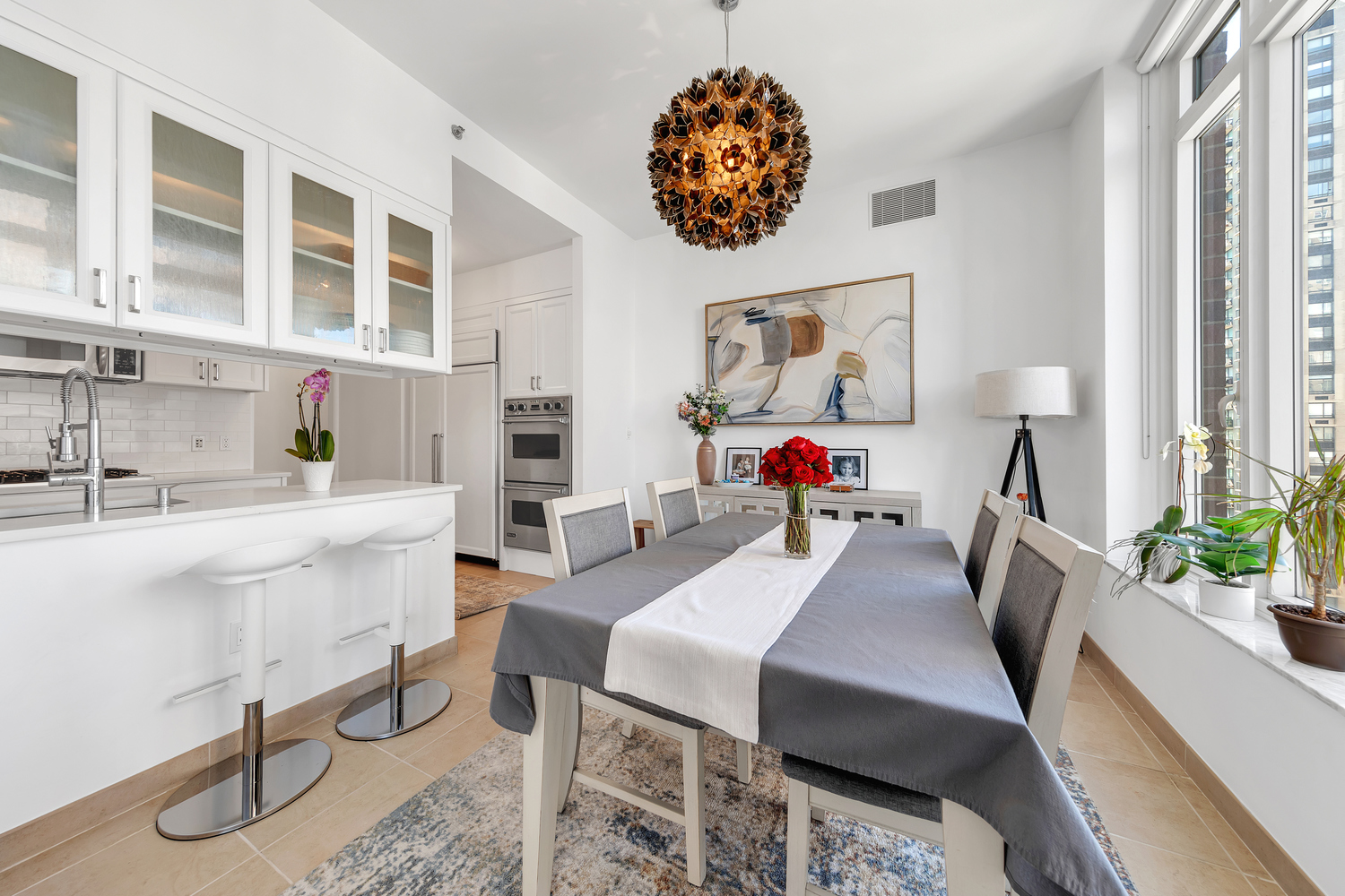 205 East 85th Street, Unit 19E Manhattan, NY 10028 - Photo 3 of 18 a living room with furniture a table and a chandelier