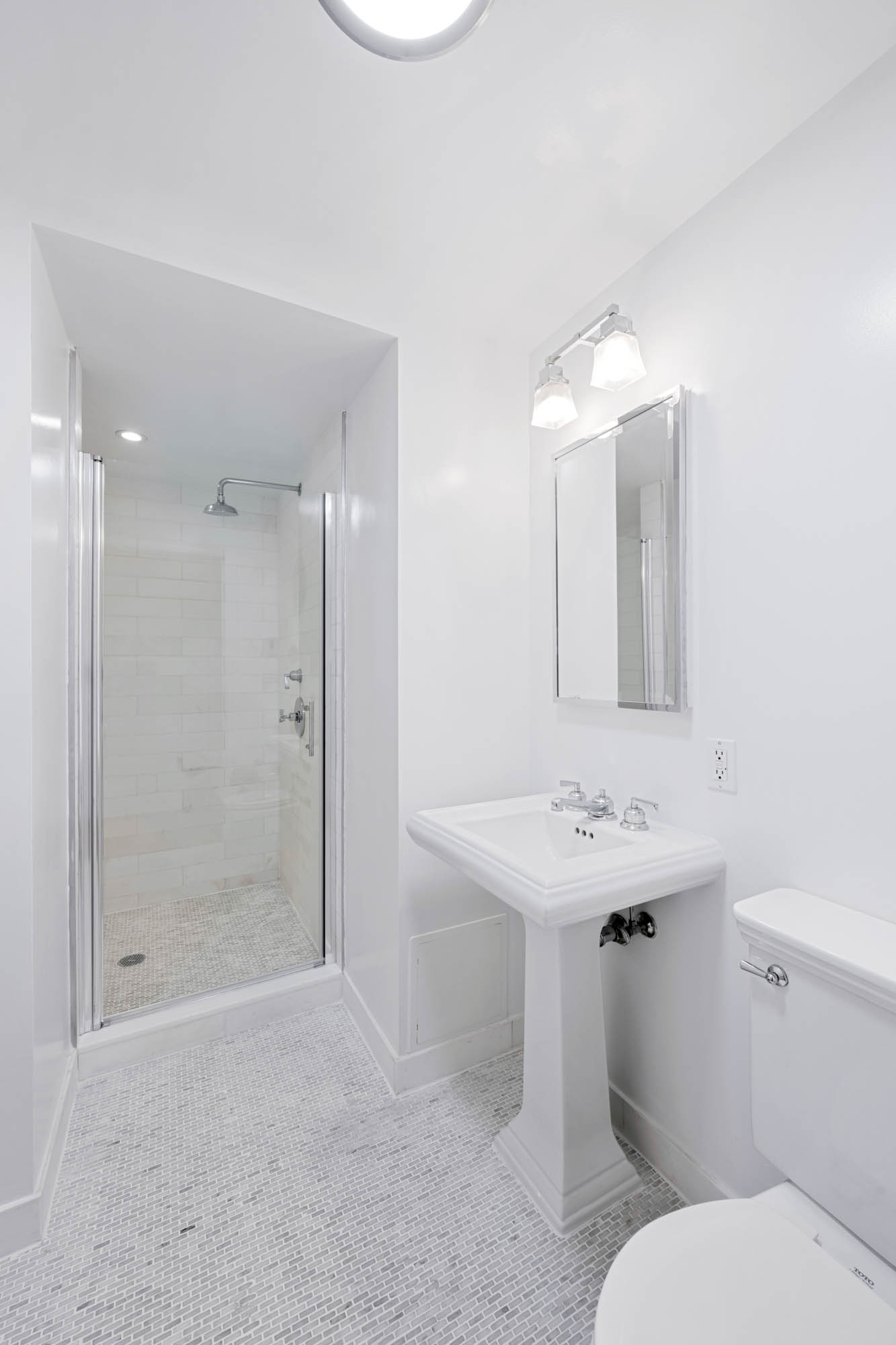 230 Riverside Drive, Unit 8D Manhattan, NY 10025 - Photo 13 of 19 a bathroom with a sink toilet and shower