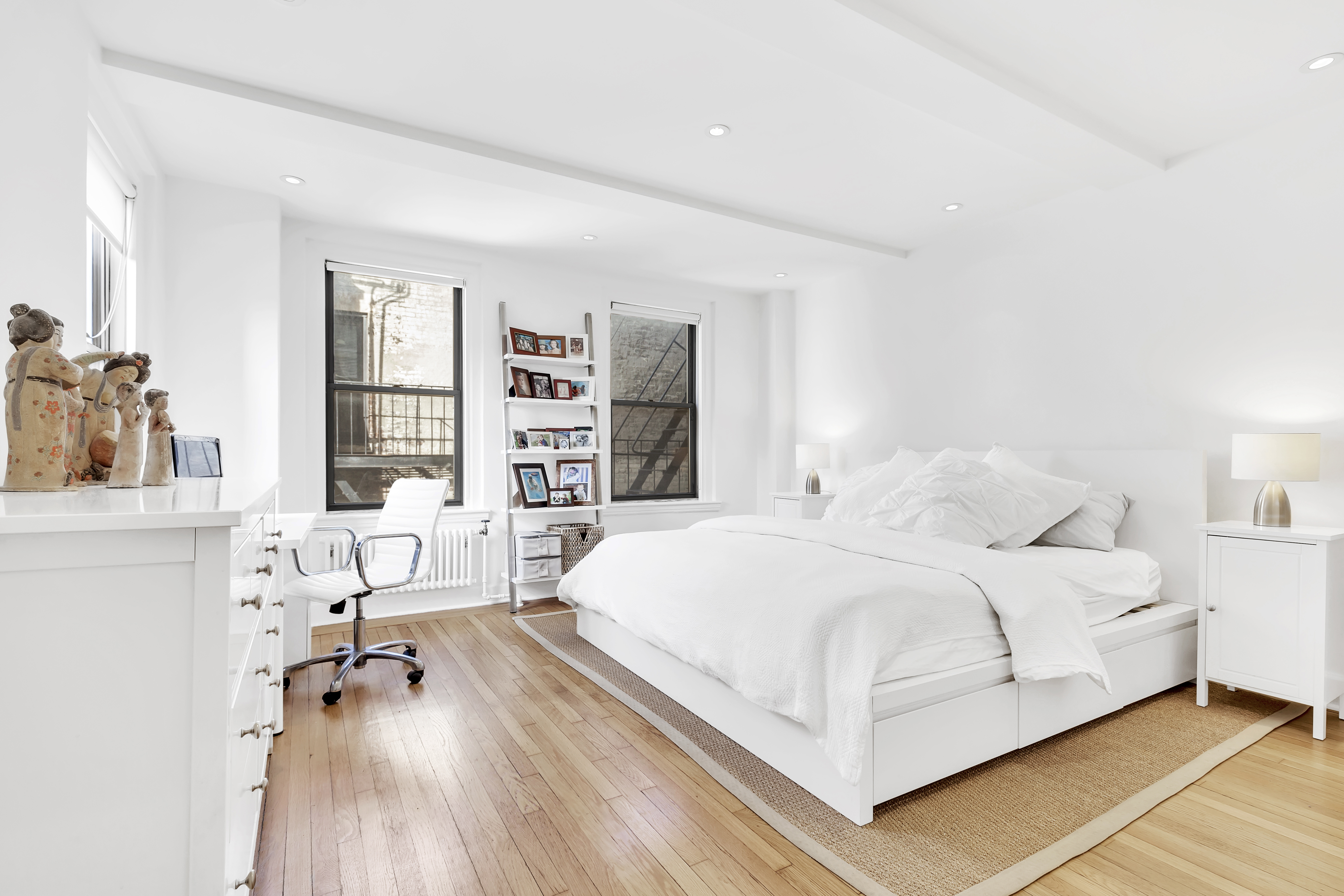 136 Waverly Place, Unit 6E Manhattan, NY 10014 - Photo 4 of 6 a bedroom with a bed and a wooden floor