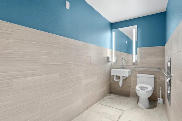 a bathroom with a toilet and a shower